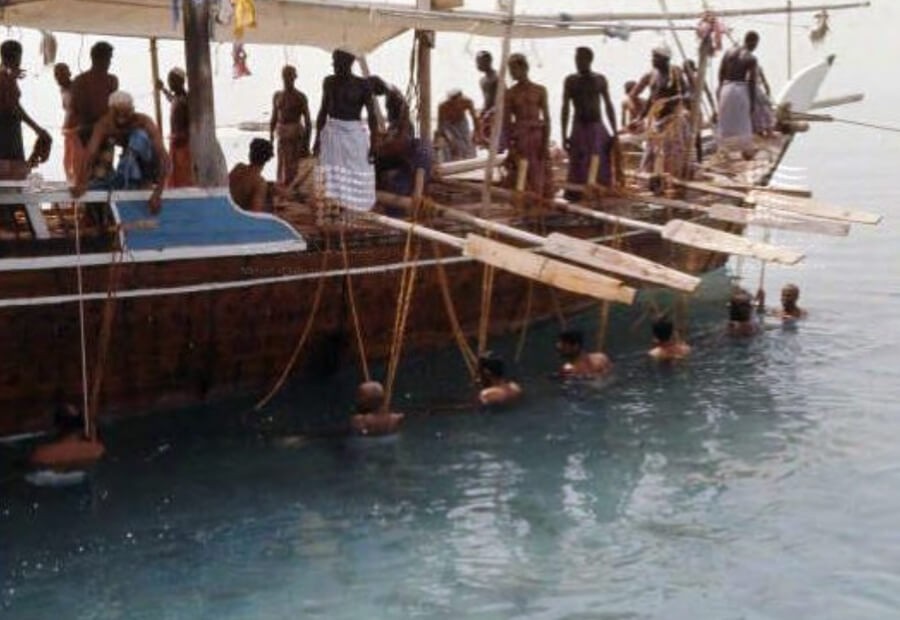Pearl divers rest alongside the boat after a dive offshore Abu Dhabi.jpg